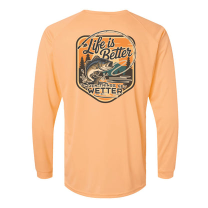 Peach long-sleeve shirt with a fishing graphic and text on the back against a white background