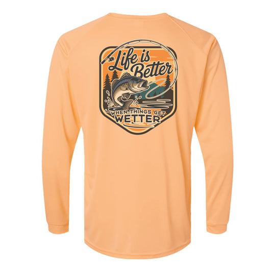 Peach long-sleeve shirt with a fishing graphic and text on the back against a white background
